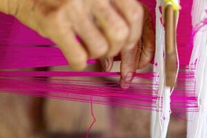 Hands Weaving Pink Thread photo