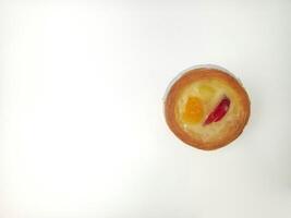 Delicious mini fruit tart isolated on white background with top view shoot. Soes cake with fruit topping. photo