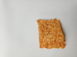 A piece of tempe or fried tempeh isolated on white background photo
