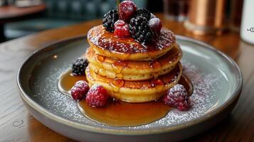 Stack of Pancakes With Syrup and Berries on a Plate photo