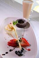 Chocolate fondant with strawberries, Chocolate fondant with strawberries and spoon on plate, isolated on white background, top view photo