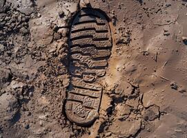 Shoe print imprint in wet mud photo