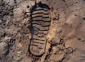 Shoe print imprint in wet mud photo