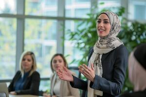 Muslim businesswoman presenting proposal in meeting photo