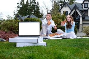 teenagers couple of young people together at picnic boys girl pizza boxes show class thumb smile pizzeria ad laptop with white screen spend time on weekend during after school holidays photo