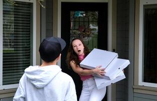 failed pizza delivery delivery guy threw three untitled boxes with white space for text ad to girl near door she caught opened mouth dissatisfied customer bad delivery trouble scandal swear quarrel photo