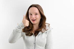 smiling girl in a grey dress on a white background photo