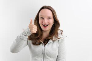 smiling girl in a grey dress on a white background photo