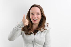 smiling girl in a grey dress on a white background photo