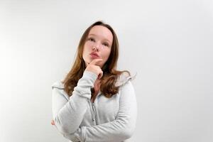 Front view of pensive pretty woman. Curly girl thinking on white background. photo