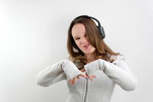 Girl With Headphones Singing and Dancing On White Background photo