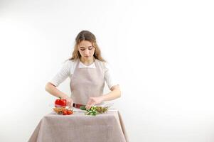 Cook holds knife in hand and cuts on cutting board green onions for salad or fresh vegetable soup with vitamins. Raw food and vegetarian recipe book in modern society popular concept. photo