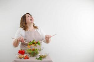 Portrait of happy playful woman space for advertising cooking blog cook dinner stir salad bowl and winking isolated on white background raised her head and laughs out loud sincerely photo