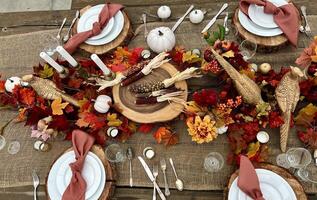 Wooden huge Table massive on which there are devices on wooden stands Mystical mysterious Halloween crows and other golden birds sit on the table Autumn bright orange and yellow flowers dry up photo