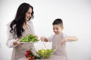 Woman and little boy having a healthy salad for snack photo