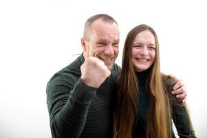 Victory win satisfied faces hugs girl clenched fist with joy shows we won Our victory on white background result of game football match end of project successful business plan hiring in office family photo