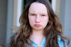 girl teenager offended pouted her lips looks into the frame 13 15 years old Offended little boy looking at camera. Caucasian appearance. Bad emotional state. No mood. Light-skinned kid. Punished baby photo