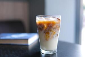 Ice latte with lactose-free milk oat or banana almond coconut milk in a delicious sweet drink close-up macro photography stir add ice several s photo