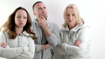 three dissatisfied indignant people a man two women a young teenage girl middle-aged people look evilly into the frame and dance an angry look photo