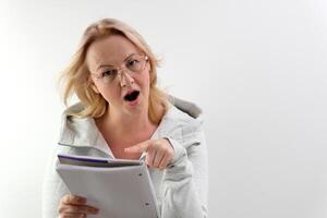 Businesswoman is looking at you holding glasses over white background photo