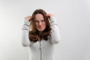 negative emotion of adolescence brain explosion girl with her hands shows how it explodes in her head experiences opens mouth waves hands boom strong explosion on a white background emotional teenager photo