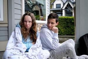 Sad pensive young girl thinking of relationships problems sitting on sofa with offended boyfriend, conflicts in friendship upset couple after fight dispute, making decision of breaking up get divorced photo