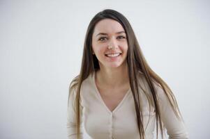 sincere smile of a young European woman Ukrainian laughter joy sparkle in her eyes on a white background a cute girl with long hair looks into the frame photo