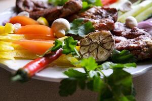Shish kebab with mushrooms, cherry tomato and sweet pepper, Grilled meat skewers. Top view, copyspace. most important meat dish of Turkish cuisine kebabs is a rich product that is cooked on embers photo