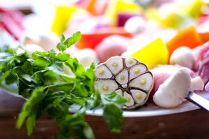 Raw meat skewers with vegetables on wooden background photo