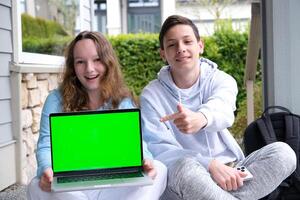 prompting solution of problem boy and girl sitting on street doing school assignments portfolio notebook folder with sheets pencil Two cups of tea coffee pleasant relationship teenager boy photo
