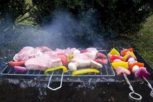 Meat and vegetables are fried on skewers. Close up. photo