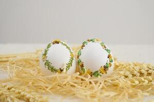 Colourful Easter eggs with different patterns aligned on a blue background photo