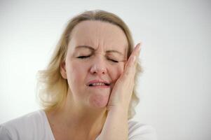 toothache woman holding hand on cheek touching tongue tooth closing eyes frowning eyebrows toothpaste ad in dentistry proper nutrition sweets without damage to teeth take care of health sadness photo