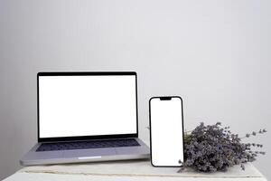 using mobile smart phone, black screen phone, sms, calls, office desk resume info and blank screen on tablet, purple lavender flower find work concept. View office desk. photo