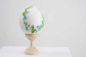 Easter holiday on stand is white egg with blue embroidery cornflowers delicate flowers embroidery with ribbons handmade congratulations postcard invitation place for text beautiful unreal photo