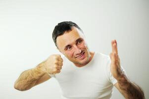 Hit from the left adult man is angry and hits his hand with his fist his hairy strong hands he has black hair and gray Dissatisfaction expressing negative emotions You will get what you deserve photo