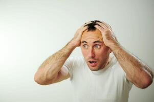 Appalled man emotional guy feeling sinking heart shortness of breath about emotional stress sensations isolated on grey white studio background, frightened person, horror, panic attack concept photo