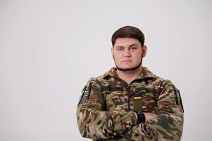 man in military uniform on white background inscription on form of armed forces of Ukraine emblem Ukrainian flag invincible Glory to Ukraine Heroes Glory place for text Victory of Ukraine war veteran photo