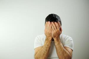 Adult man upset he put his hands on his face Prayer experience crying negative emotions suffering loneliness Studio on white background Close-up space for text Waiting for the end of the war photo