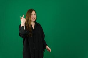 woman teenager in studio photo with green background doing poses and facial expressions