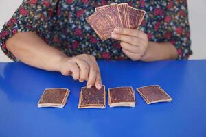 Close up hands hold, choose and pick up paper cards. concept, fortune reading. astrology. Foretelling, mystery, magic, fortune, fate. Prediction for future life ,events. photo