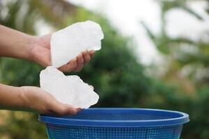 Close up hand holds crystal clear white alum stones or Potassium alum Useful for beauty and spa treatment. Use to treat body odor under the armpits as deodorant and make water clear photo