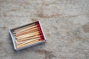 Box of matches wooden sticks with red sulfur. Concept, tool or equipment used for igniting fire made from small wooden sticks. with flammable substance on one end. photo