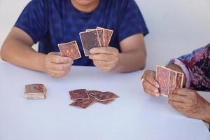 Close up man and woman are playing paper cards. Concept , recreational activity. Free time and hobby. Fortune reading from cards. Prediction for future life ,events. Astrology. Foretelling. photo