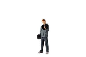 Miniature people , Young man lifting weights Isolated on white background with clipping path photo