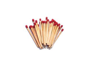 Pile of matches wooden sticks with red sulfur, isolated on white background. Concept, tool or equipment used for igniting fire made from small wooden sticks. with flammable substance on one end. photo