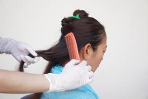 Close up hairdresser is combing hair female client before doing hairstyle. Concept. Woman shouldn't stop beauty. Hair health care. Change hair color, cover gray hair with dye color. Hairstylist. photo