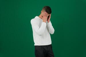 Asian business man stress from everything emotions of a handsome man guy on a green background chromakey close-up dark hair young man photo