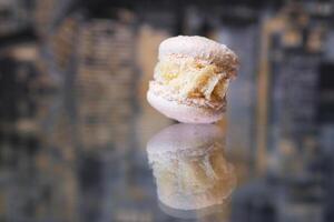 Pink strawberry macaroon isolated on white background. French cookie. Raspberry purple cake in a front view. Bakery concept with blank space photo