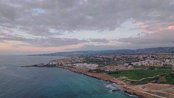 Coastal Beauty. Aerial Views of Paphos, Cyprus' Urban Landscape and Seaside Homes Glowing in the Sunset. High quality 4k footage video